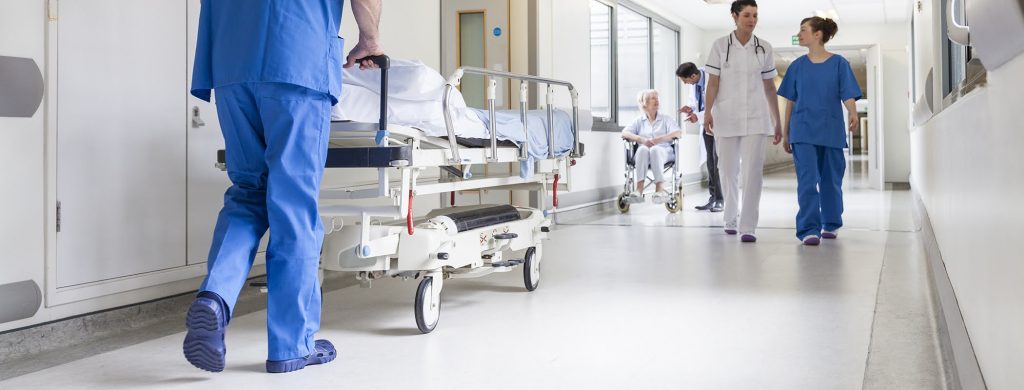 Doctors Hospital Corridor Nurse Pushing Gurney Stretcher Bed