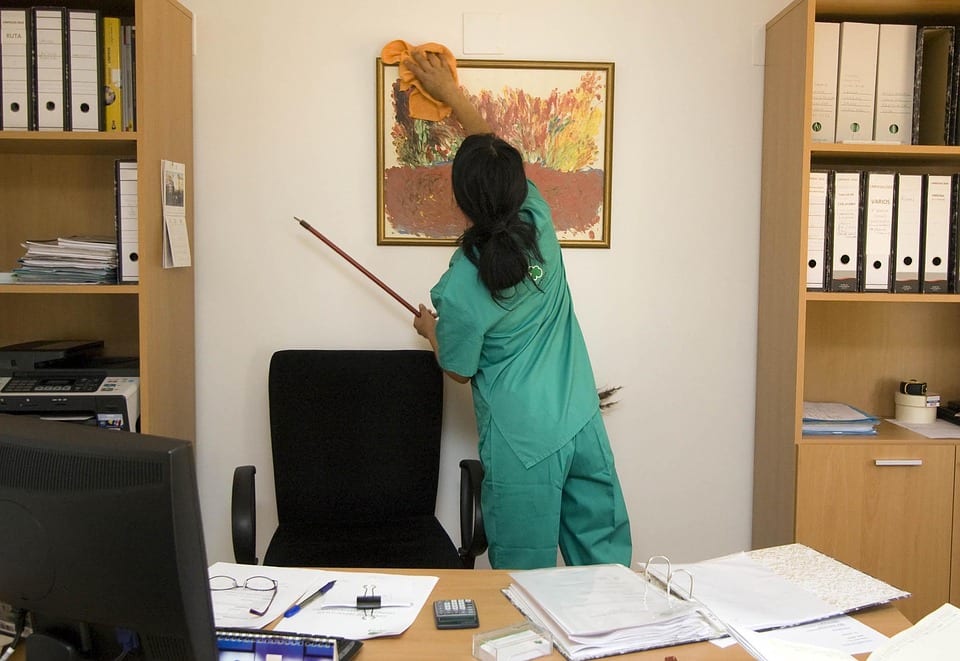 lady staff cleaning walls