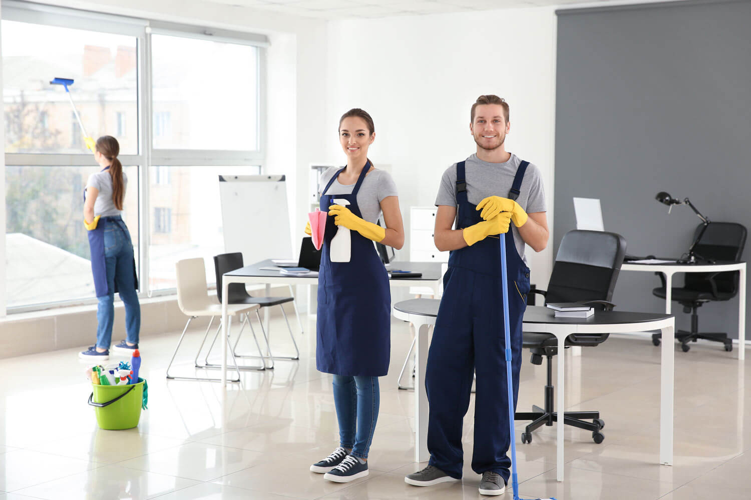 staff in a room holding mops