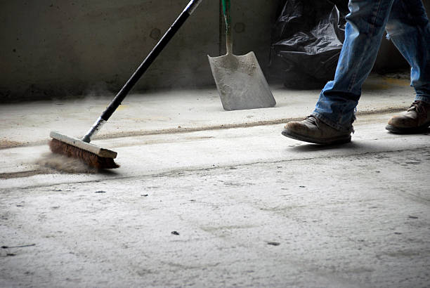 Man Sweeping A Concrete Floor