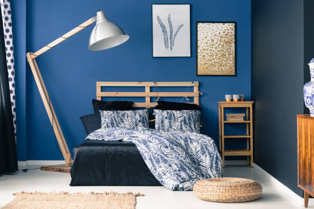 Deep indigo tones in classy bedroom with shiny metallic details