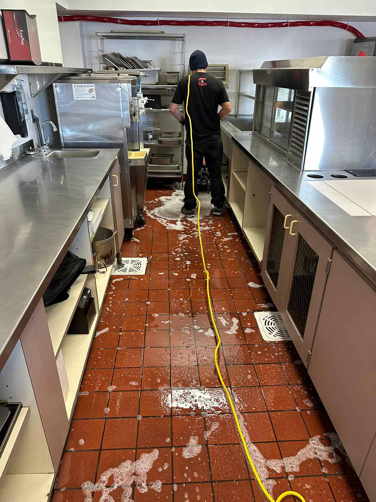Cleaning-Red-Tiled-Floor-in-a-Restaurant-scaled